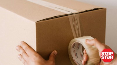 person taping a box