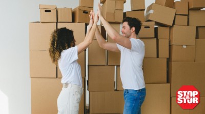 couple high fiving in front of storage boxes