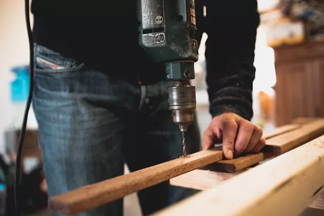 person drilling wood