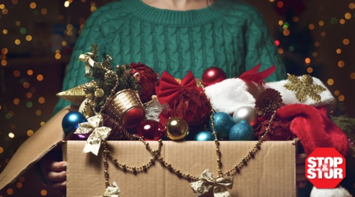 https://www.stopandstor.com/sites/default/files/styles/max_700_fallback/public/2023-03/woman%20wearing%20sweater%20holding%20christmas%20storage%20box%20full%20of%20ornaments.png.jpeg?itok=C_caTEyL